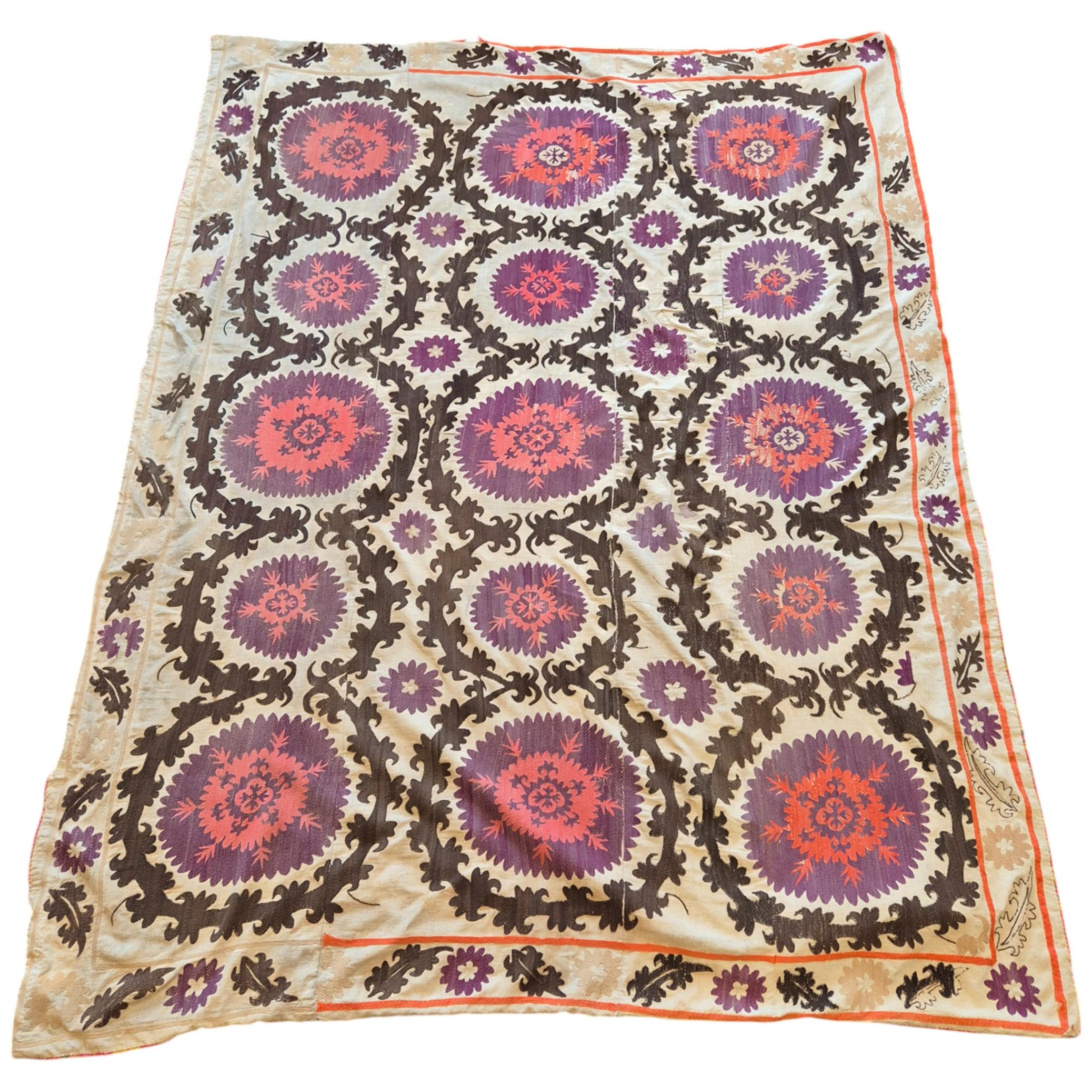 A late 19th early 20th century Uzbekistan (possibly Samarkand) embroidered Suzani. Made from hand loomed linen, pieced together then hand embroidered with large decorative sun or moon motifs as a large table cover or han